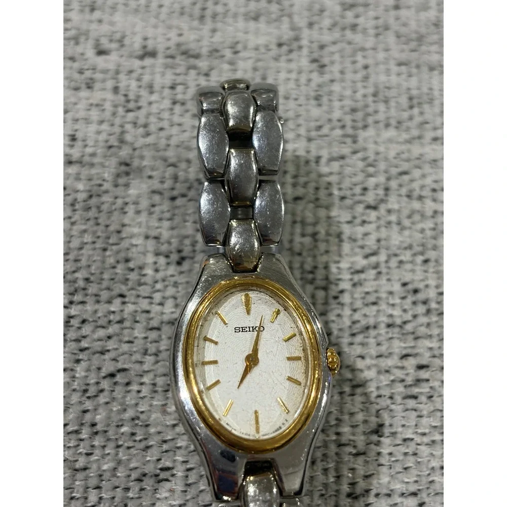 Seiko Oval Women's Two Tone Silver and Gold Wrist  Sunburst Dial Watch 1N00-6F80